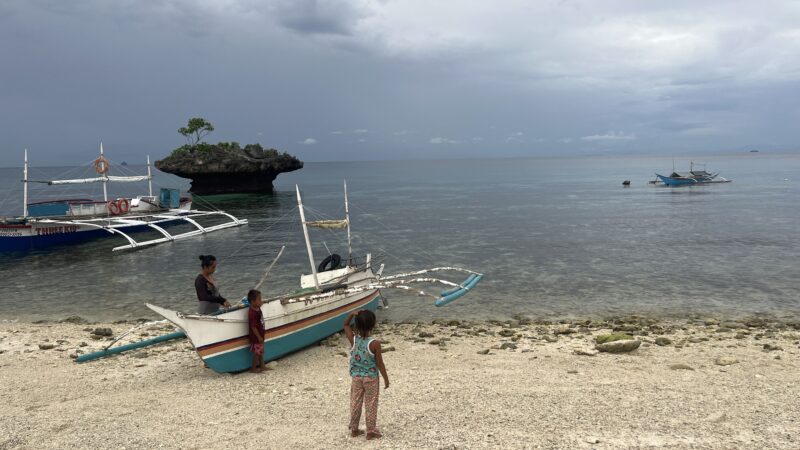 Fishermen With Boats On Philippine Island
