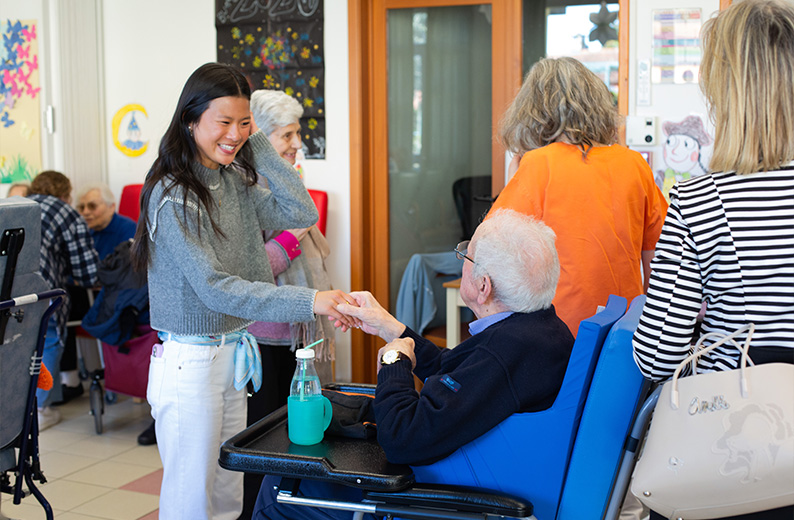 Girl Shaking Hands With Elderly Man